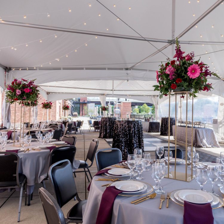 Tent at National Comedy Center decorated with florals and linens for a private event